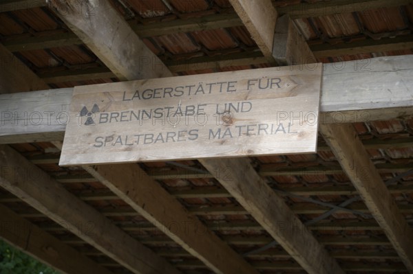 Wooden sign under a roof with reference to a deposit for fuel rods and fissile material, Niedersachsem, Germany
