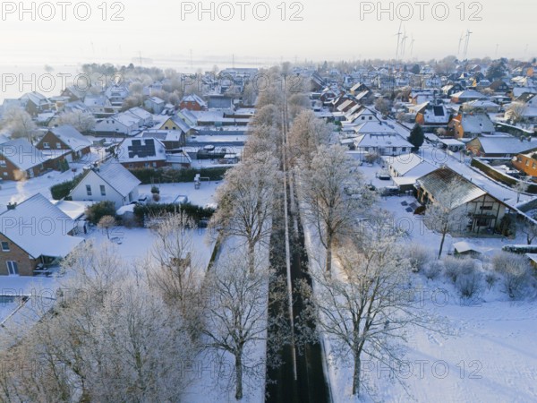 Snowy village with tree-lined avenue and snow-covered houses, aerial view, winter, hoarfrost, Adenstedt, municipality of Ilsede, district of Peine, Lower Saxony, Germany