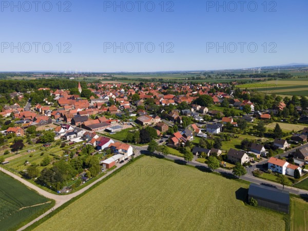 Summer village landscape with red roofs and surrounding fields, Adenstedt, Ilsede municipality, Peine district, Lower Saxony, Germany