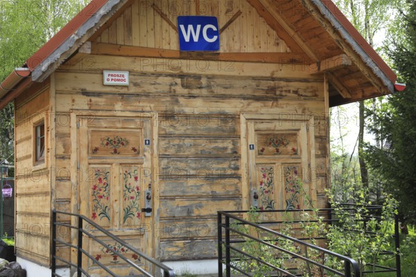 Traditional wooden houses in the village of Chocholow, Podhale-style wooden architecture, listed by UNESCO, even the public toilet is adapted to the style, near Zakopane, Lesser Poland Voivodeship, Poland