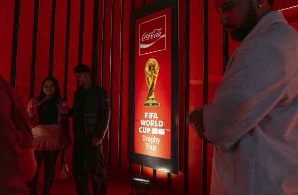 Football fans poses for a photograph with the original FIFA World Cup 2026 Trophy during the official India tour in Guwahati, Assam, India, on January 13, 2026