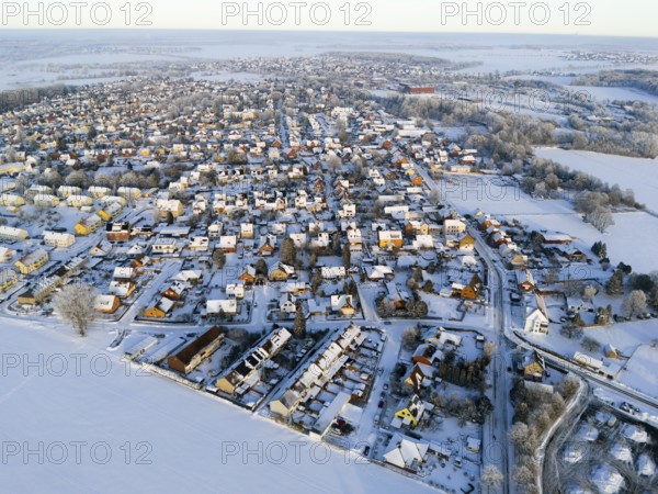 Overview of a snowy village with houses and surrounding fields in the evening light, Aerial View, Oelsburg, Ilsede, Peine District, Lower Saxony, Germany
