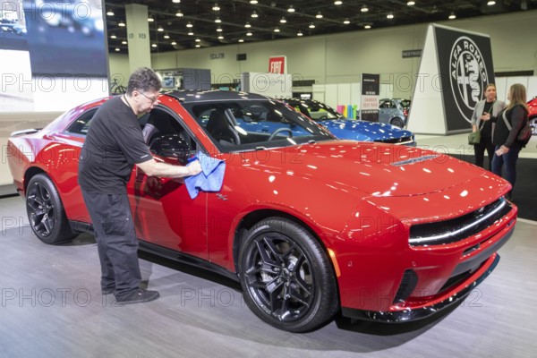Detroit, Michigan USA - 14 January 2026 - A worker polishes the Dodge Charger Sixpack at the Detroit Auto Show