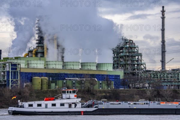 Shipping traffic on the Rhine near Duisburg-Bruckhausen, industrial setting of the ThyssenKrupp steel plant, cooler on the so-called white side of the Schwelgern coking plant, North Rhine-Westphalia, Germany