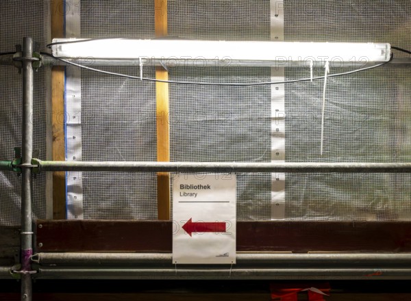 Technical University in Berlin, provisional information sheets and signs at an indoor construction site show the way towards the library, Berlin, Germany