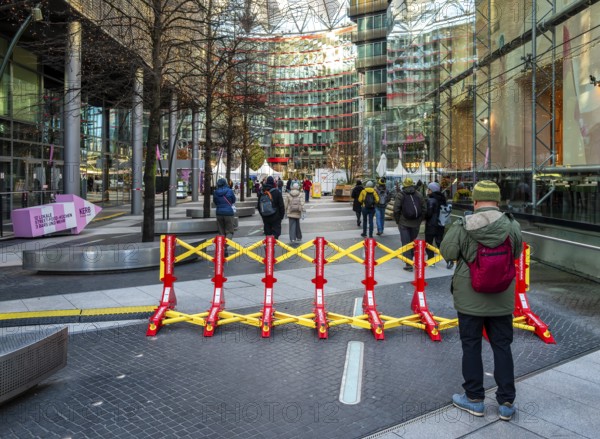 Massive metal access barriers in red and yellow at Center Potsdamer Platz, Berlin, Germany