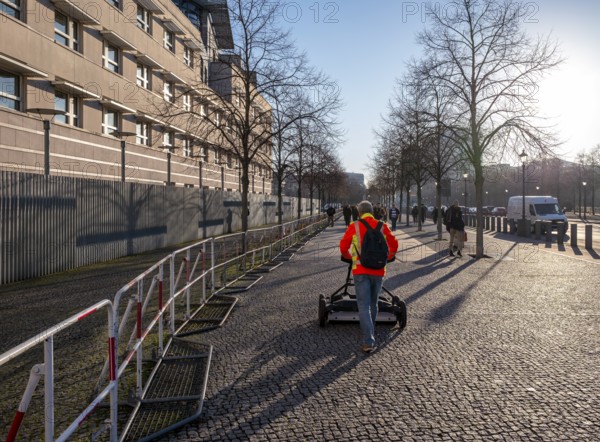 Measurement of the walkway at the Brandenburg Gate near the American Embassy, Berlin, Germany