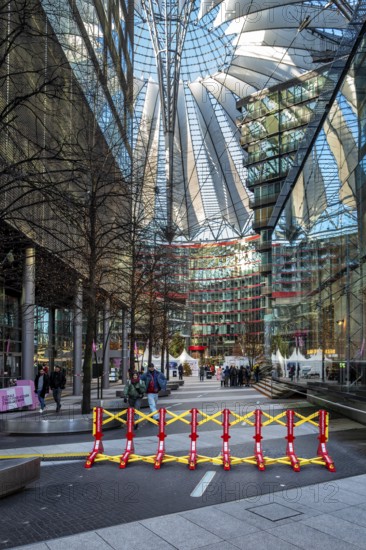Massive metal access barriers in red and yellow at Center Potsdamer Platz, Berlin, Germany