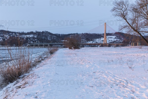 Niederwartha Elbe Bridge, cold winter morning on the Elbe with floating ice floes, snow and dawn at sunrise, Kötzschenbroda, Radebeul, Saxony, Germany