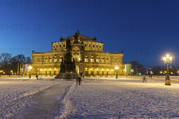 Illuminated Semper Opera House and Theatre Square with snow at dusk, Old Town of Dresden, Saxony, Germany