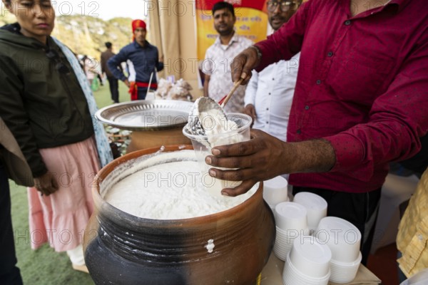 Vendor selling curd and cream dairy product at a stall in Bhogali Mela, ahead of the 'Magh Bihu' festival, in Guwahati, Assam, India on January 12, 2026. Magh Bihu, also called Bhogali Bihu, is Assam's harvest festival marking the end of the agricultural season and celebrated with feasts, community bonfires, and traditional food
