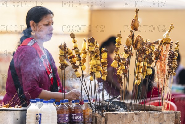 Vendor selling roasted meat at a stall in Bhogali Mela, ahead of the 'Magh Bihu' festival, in Guwahati, Assam, India on January 12, 2026. Magh Bihu, also called Bhogali Bihu, is Assam's harvest festival marking the end of the agricultural season and celebrated with feasts, community bonfires, and traditional food