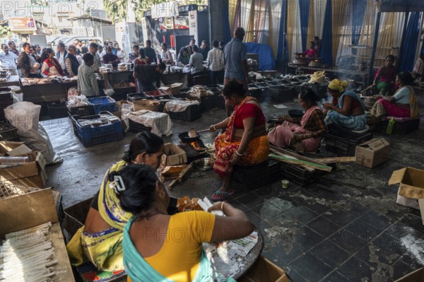Women prepare 'Pitha', Assamese traditional rice-based sweets or snacks, as part of preparations ahead of the 'Magh Bihu' festival, in Guwahati, Assam, India on January 12, 2026. Magh Bihu, also called Bhogali Bihu, is Assam's harvest festival marking the end of the agricultural season and celebrated with feasts, community bonfires, and traditional food
