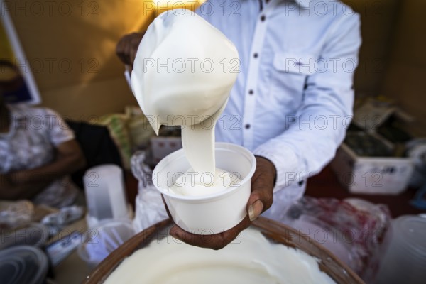 Vendor selling cream dairy product at a stall in Bhogali Mela, ahead of the 'Magh Bihu' festival, in Guwahati, Assam, India on January 12, 2026. Magh Bihu, also called Bhogali Bihu, is Assam's harvest festival marking the end of the agricultural season and celebrated with feasts, community bonfires, and traditional food