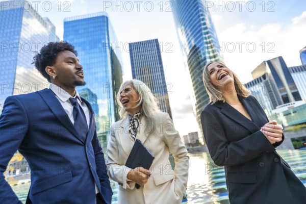 Diverse business professionals walking and laughing together outside modern corporate buildings, symbolizing teamwork, success, and positive collaboration in a metropolitan financial district