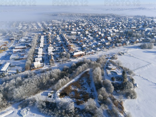 Aerial view of snowy city with fog and frost-covered fields, trees and buildings, aerial view, winter, snow, Groß Ilsede, municipality of Ilsede, district of Peine, Lower Saxony, Germany