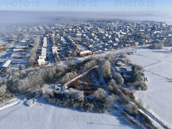 Snowy city landscape from the air with frost-covered houses and fields under blue sky, aerial view, winter, snow, Groß Ilsede, municipality of Ilsede, district of Peine, Lower Saxony, Germany