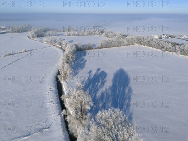 Winter peace with snow-covered fields and frosty trees under a clear blue sky, Fuhse river, Bülten, Ilsede, Peine district, Lower Saxony, Germany