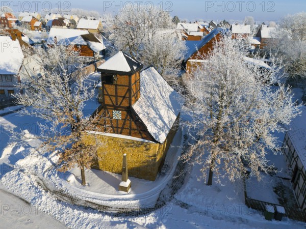 Snowy half-timbered church in wintry village against clear blue sky, aerial view, Old Chapel, 15th century, snow, hoarfrost, Bülten, Ilsede, Lower Saxony, Germany
