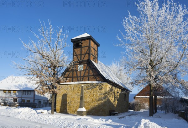 Snowy half-timbered church with blue sky and snow-covered trees in the background, Old Chapel, 15th century, snow, hoarfrost, Bülten, Ilsede, Lower Saxony, Germany