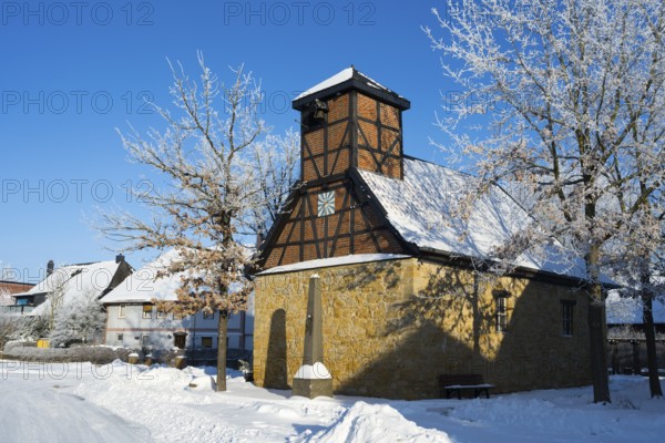 Snowy frame house in a village surrounded by snow-covered trees and clear sky, Old Chapel, 15th century, snow, hoarfrost, Bülten, Ilsede, Lower Saxony, Germany
