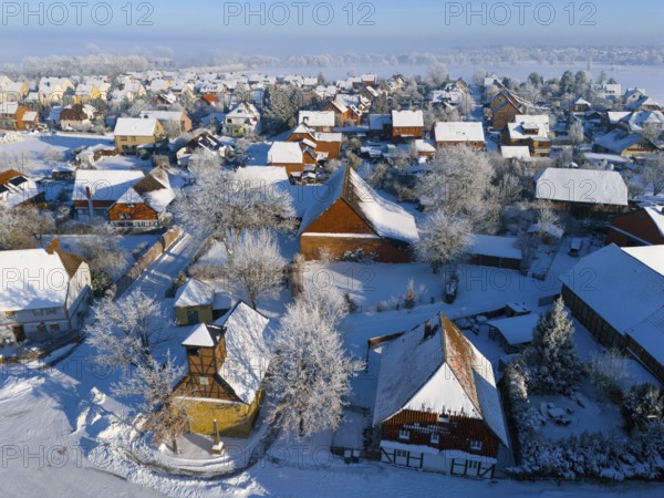 Winter village with snow-covered roofs and half-timbered buildings, cold, peaceful atmosphere, aerial view, Old Chapel, 15th century, snow, hoarfrost, Bülten, Ilsede, Lower Saxony, Germany