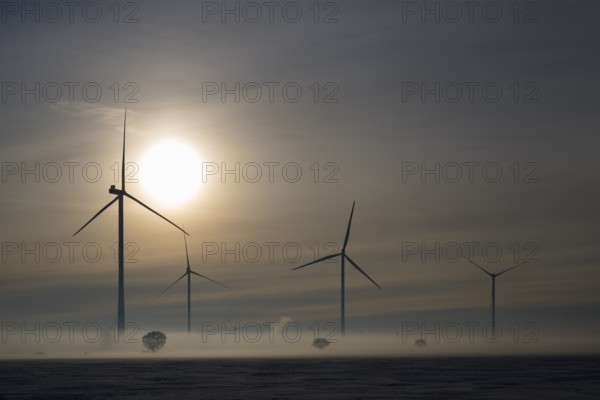 Wind turbines at sunset in a foggy winter landscape, wind turbines between Solschen and Adenstedt, Ilsede, Peine district, Lower Saxony, Germany