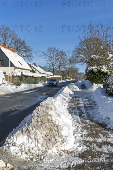 Snowy road, car, houses, winter, snow, Sieversen, Samtgemeinde Rosengarten, Lower Saxony, Germany