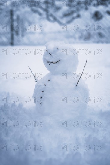 A small snowman stands alone in the snow, surrounded by winter silence, Waldachtal, Freudenstadt district, Germany