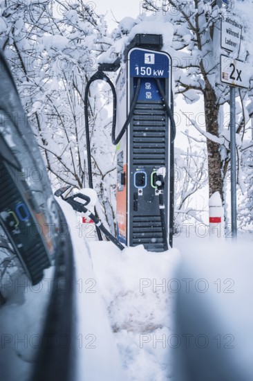 150 kW charging station in snowy surroundings next to an electric car, Tesla Model Y electric car, ENBW charging station, Waldachtal, Freudenstadt district, Germany