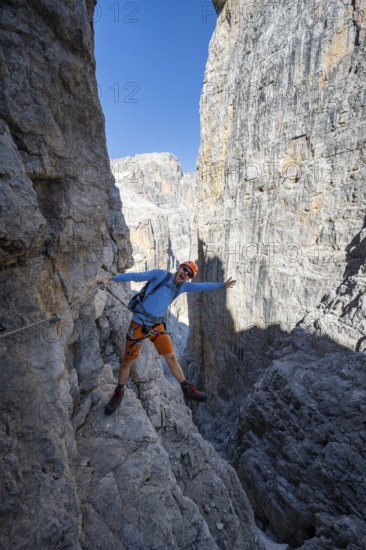 Mountaineers happy on the Via Ferrata Bocciere Centrale via ferrata, spectacular mountain landscape with steep rock faces, Brenta Mountains, Parco Naturale Brenta-Adamello, Trentino, Italy