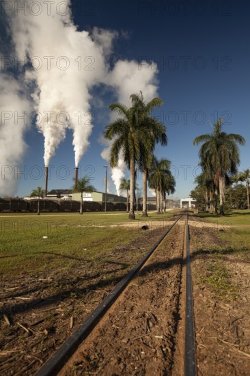 August 19, 2020, Sugar Mill. Industrial chimneys smoking under a clear blue sky on a bright sunny day. Tully, Queensland, Australia