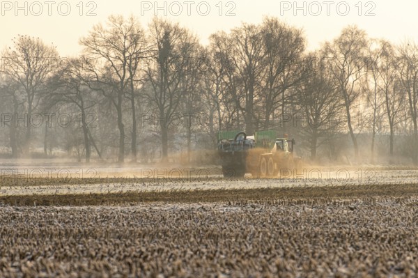 Tecker with slurry tank in winter landscape, Elsten, Lower Saxony, Germany