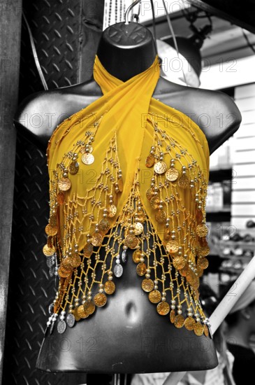 Decorated yellow cape on a black torso, black and white, New York City, USA