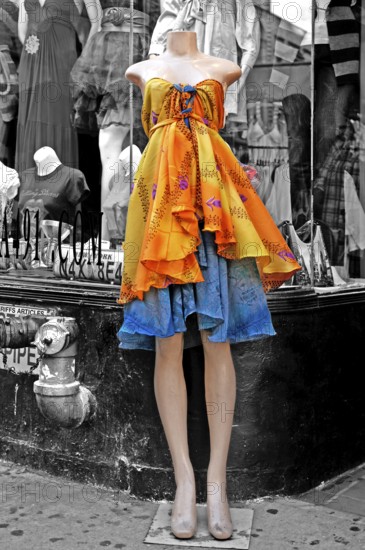 Headless mannequin dressed in colorful cloths in front of a fashion shop, black and white, New York City, USA