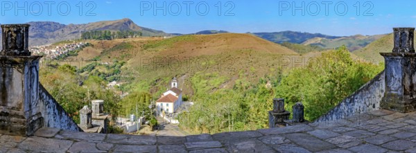 Historic churches and mountains of the city of Ouro Preto seen through stone columns, Ouro Preto, Minas Gerais, Brazil