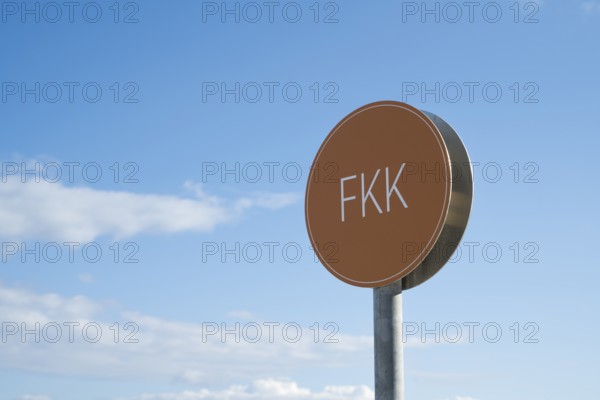 Naturist sign against blue sky with white clouds, Binz, seaside resort, Rügen island, Baltic Sea, Mecklenburg-Western Pomerania, Germany