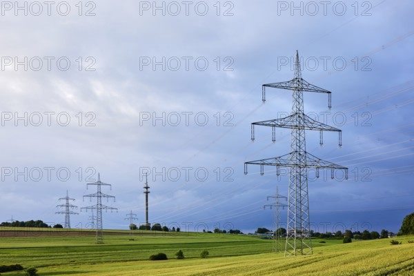 Landscape, high-voltage pole, high-voltage line, fields, trees, bushes, cloudy, sunny, stratocumulus clouds, cumulonimbus clouds, thunderstorm, Ralingen, Trier-Saarburg district, Rhineland-Palatinate, Germany
