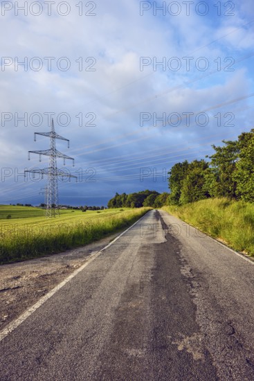 Landscape, road, high-voltage line, high-voltage mast, fields, trees, bushes, meadow, cloudy, stratocumulus clouds, cumulonimbus clouds, sunny, thunderstorm, Ralingen, Trier-Saarburg district, Rhineland-Palatinate, Germany