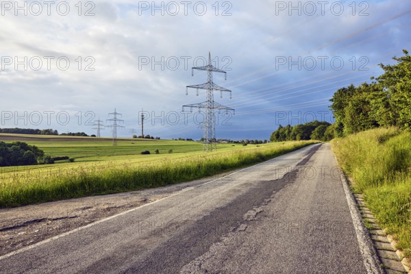 Landscape, road, high-voltage power line, high-voltage pole, television tower, fields, trees, bushes, meadow, cloudy, stratocumulus clouds, cumulonimbus clouds, sunny, thunderstorm, Ralingen, Trier-Saarburg district, Rhineland-Palatinate, Germany