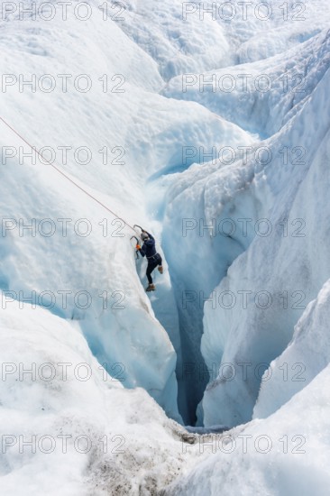 Ice climbers in an ice canyon, Root Glacier, Wrangell St. Elias National Park, Alaska, USA