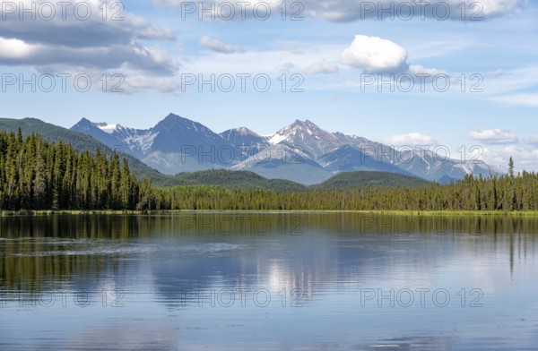 Mountains are reflected in idyllic Crystal Lake, McCarthy Highway, Wrangell St. Elias National Park, Alaska, USA