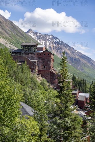 Red Kennicott buildings in front of mountainous landscape, Kennicott Concentration Mill to extract copper from quarried rock, Historic Kennecott Copper Mine, National Historic Landmark, Wrangell St. Elias National Park, Alaska, USA
