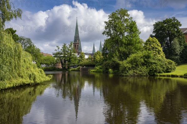 View of St. Lambert's Church from the castle pond in the castle park in Oldenburg, Oldenburg, Lower Saxony, Germany