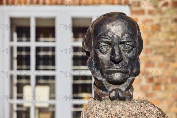 Bust of Lorenz von Stein, sculptor Manfred Sihle-Wissel, brick building, historic town hall, façade, depth of focus with blurred background, sunny, Rathausplatz, Rathausmarkt, Eckernförde, Rendsburg-Eckernförde district, Schleswig-Holstein, Germany