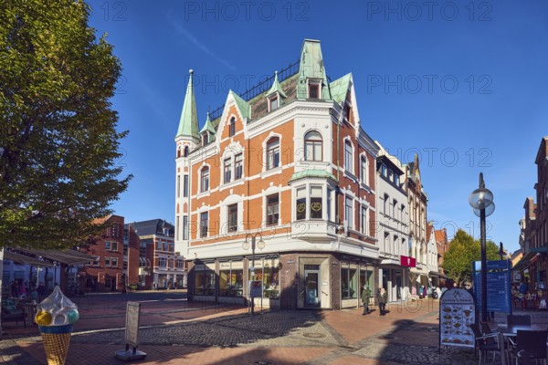 Jeweler Jacobsen, historic residential building and commercial building, façade with windows and plaster structure, bay window, ridge decoration, dormer, pointed gable, turret, slate-covered mansard roof, architect Wilhelm Kruckau, pedestrian zone, retail stores, shops, shopping, lantern, trees, pedestrians as accessories, blue sky, cirrus clouds, intersection between Kieler Straße and Schulweg and Rathausmarkt, Eckernförde, Rendsburg-Eckernförde District, Schleswig-Holstein, Germany
