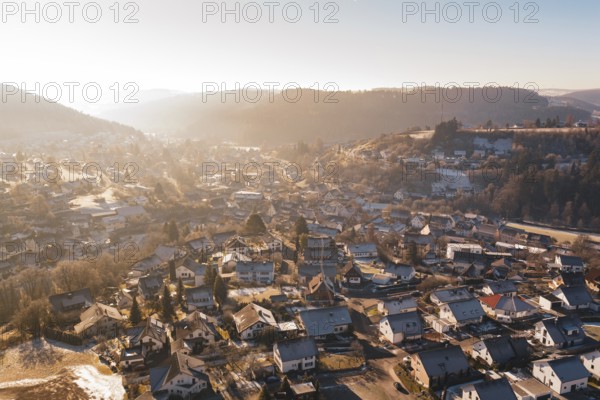 Overview of a village with wintry roofs and hills, Glatten, Freudenstadt district, Germany
