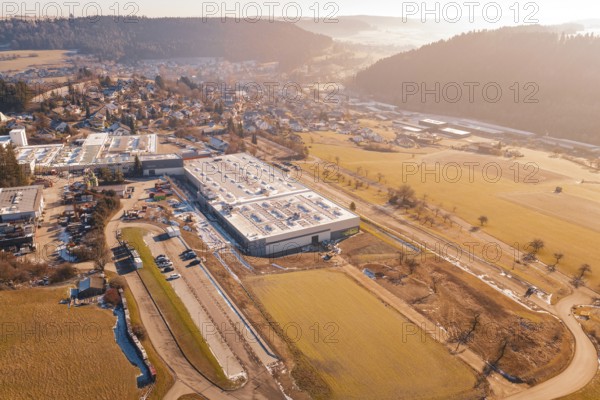 Factory building next to village and snow-covered fields, Glatten, Freudenstadt district, Germany
