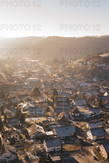 A village in a hilly landscape in the warm light of sunset, Glatten, Freudenstadt district, Germany