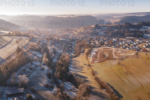 Snowy village in mountainous landscape under morning light, Glatten, Freudenstadt district, Germany